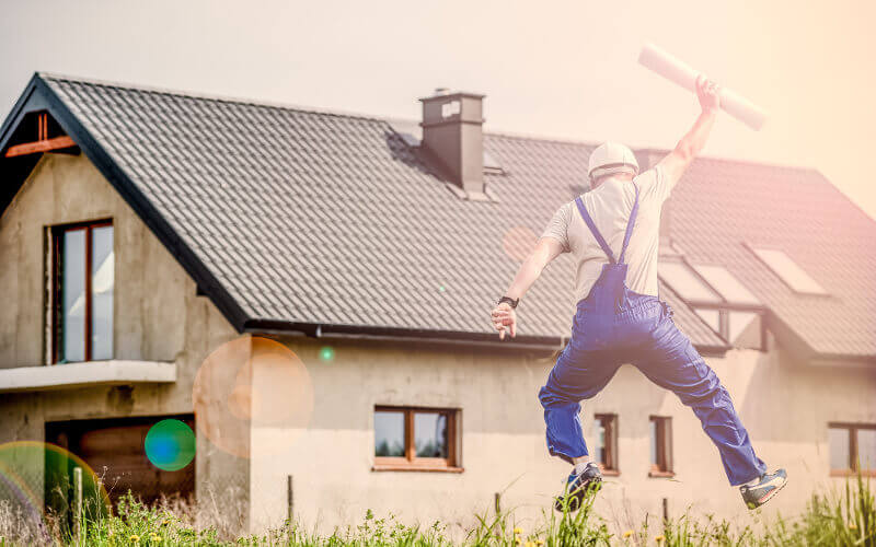 Construction worker jumping in celebration